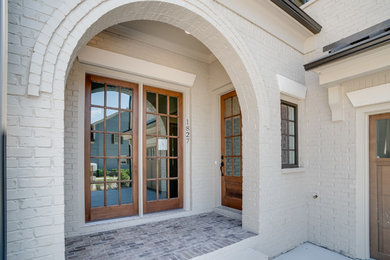 Inspiration for a large timeless white two-story brick exterior home remodel in Atlanta