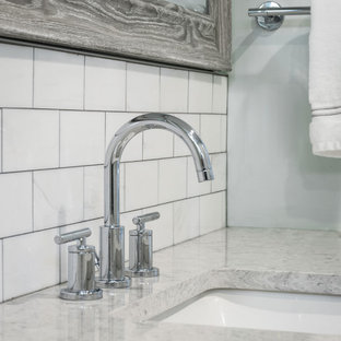 Example of a mid-sized minimalist master gray tile and slate tile ceramic floor and gray floor alcove shower design in St Louis with recessed-panel cabinets, white cabinets, a one-piece toilet, blue walls, a drop-in sink, quartz countertops, a hinged shower door and gray countertops