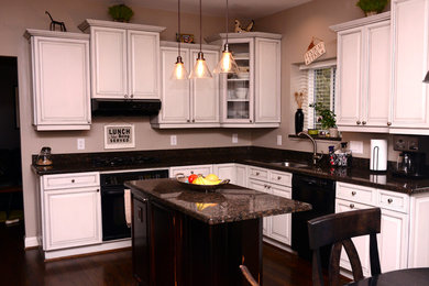 Kitchen - shabby-chic style kitchen idea in Detroit with raised-panel cabinets, white cabinets and an island