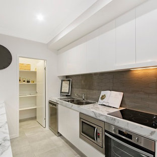 Mid-sized modern kitchen pantry ideas - Kitchen pantry - mid-sized modern single-wall porcelain floor kitchen pantry idea in Townsville with a double-bowl sink, flat-panel cabinets, white cabinets, laminate countertops, gray backsplash, porcelain backsplash, stainless steel appliances and an island