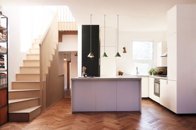 Design ideas for a contemporary living room in London with dark hardwood flooring.