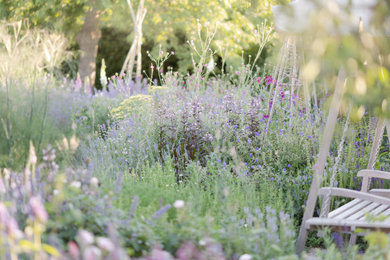 Inspiration for a medium sized traditional back formal partial sun garden for summer in Kent with a flowerbed, gravel and a wood fence.