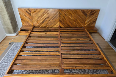 Inspiration for a mid-sized modern master medium tone wood floor and brown floor bedroom remodel in Other with blue walls and no fireplace