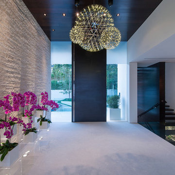 Laurel Way Beverly Hills modern home luxury foyer with pivot door, glass walls &