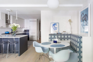 Inspiration for a small modern light wood floor and white floor kitchen/dining room combo remodel in New York with white walls