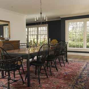 Design ideas for a large classic dining room in New York with black walls, medium hardwood flooring, no fireplace and brown floors.