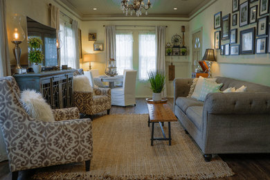 Example of a small eclectic enclosed dark wood floor and brown floor living room design in Austin with beige walls and a tv stand