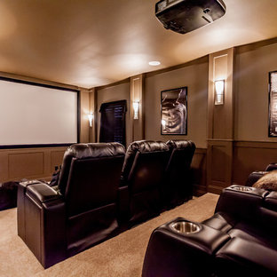 Inspiration for a large mediterranean enclosed carpeted home theater remodel in Jacksonville with brown walls and a projector screen