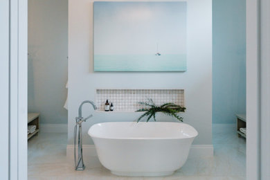 Bathroom - large transitional master beige tile and porcelain tile porcelain tile, beige floor and double-sink bathroom idea in Miami with recessed-panel cabinets, light wood cabinets, a one-piece toilet, blue walls, an undermount sink, quartz countertops, white countertops and a built-in vanity