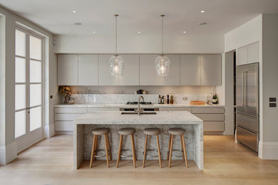 Inspiration for a contemporary kitchen in London with marble splashback.