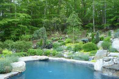Design ideas for a large traditional sloped full sun garden for summer in New York with natural stone pavers.