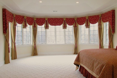 This is an example of an expansive transitional master bedroom in Philadelphia with beige walls, carpet and no fireplace.