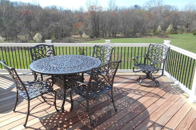 Large transitional backyard deck photo in DC Metro with no cover