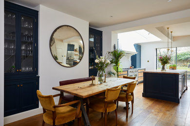 Inspiration for a large traditional open plan dining room in London with dark hardwood flooring and brown floors.