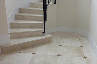 Large elegant tile curved staircase photo in Miami with tile risers