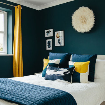 Blue bedroom with bright yellow and gold accents