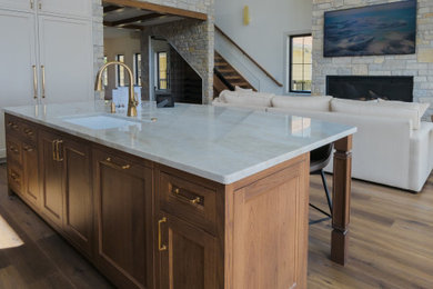 Transitional vinyl floor, brown floor and vaulted ceiling open concept kitchen photo in Other with shaker cabinets, light wood cabinets, quartz countertops, an island and white countertops
