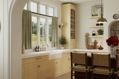 Mid-sized transitional l-shaped limestone floor and beige floor kitchen photo in New York with a farmhouse sink, shaker cabinets, yellow cabinets, quartz countertops, white backsplash, quartz backsplash, stainless steel appliances, an island and white countertops