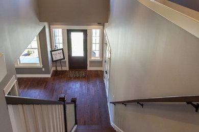 Example of a mid-sized wooden straight staircase design in Grand Rapids with wooden risers