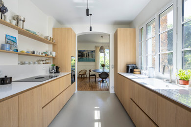 Exemple d'une cuisine parallèle tendance en bois clair fermée avec un plan de travail en quartz, une crédence blanche, une crédence en quartz modifié et un plan de travail blanc.