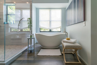 Mid-sized transitional master bathroom in Miami with a freestanding tub, a corner shower, gray tile, grey walls, light wood cabinets, mosaic tile and porcelain floors.