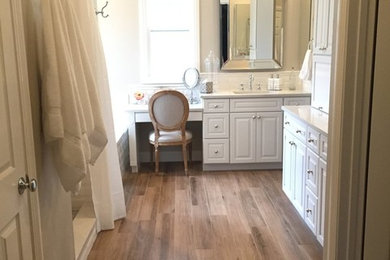 Inspiration for a mid-sized traditional master bathroom in San Diego with an alcove shower, beige walls, medium hardwood floors, an undermount sink, brown floor, a shower curtain, an undermount tub, raised-panel cabinets, white cabinets and engineered quartz benchtops.