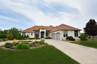 Large craftsman white two-story stone house exterior idea in Chicago with a hip roof and a shingle roof