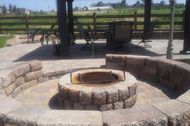 Patio - mid-sized southwestern backyard concrete paver patio idea in Denver with a fire pit and no cover