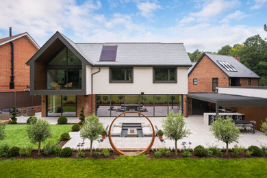Inspiration for a contemporary render and rear detached house in Berkshire with a tiled roof and a grey roof.