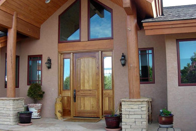 Mid-sized mountain style beige one-story stucco gable roof photo in Orange County