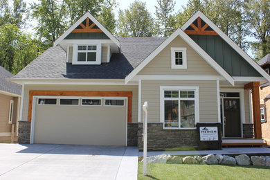 Inspiration for a mid-sized craftsman beige two-story concrete fiberboard gable roof remodel in Vancouver