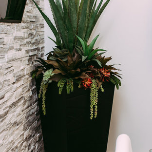 Design ideas for a large modern home office and library in Edmonton with grey walls, ceramic flooring and a hanging fireplace.