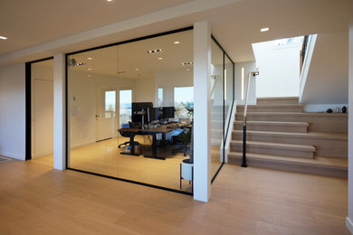 Mid-sized minimalist home office photo in Portland