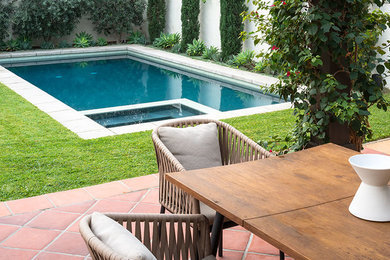 Inspiration for a mid-sized contemporary backyard rectangular lap pool in Los Angeles with a hot tub and tile.
