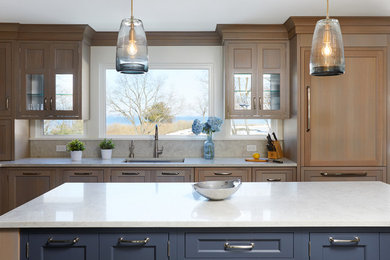 Kitchen - large l-shaped dark wood floor kitchen idea in New York with a single-bowl sink, recessed-panel cabinets, gray backsplash and two islands