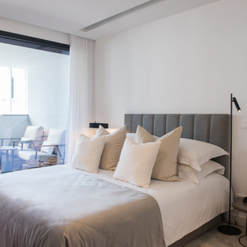 Bedroom with Channelled Gray Headboard and Terrace Access