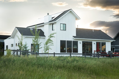 Mid-sized transitional white two-story concrete fiberboard exterior home photo in Other with a shed roof