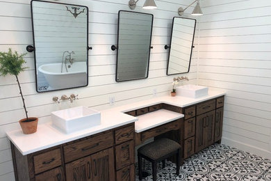 Bathroom - large country master porcelain tile and multicolored floor bathroom idea in Other with shaker cabinets, dark wood cabinets, white walls, a vessel sink, quartz countertops, a hinged shower door and white countertops
