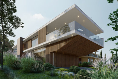 Ejemplo de fachada de casa moderna de tamaño medio de dos plantas con revestimiento de madera y tejado plano
