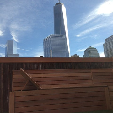 clear cedar bench with artificial turf and bamboo fence