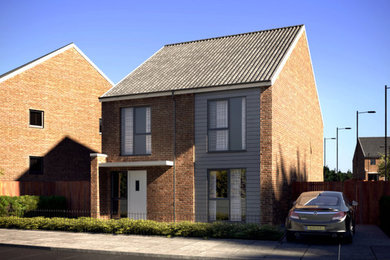 Cette image montre une grande façade de maison design en brique à un étage avec un toit à deux pans.