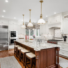 Kitchen With Cherry Wood Island And Off-White Cabinets