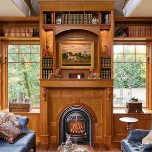 Design ideas for a victorian home office and library in Seattle with medium hardwood flooring, a standard fireplace and a wooden fireplace surround.