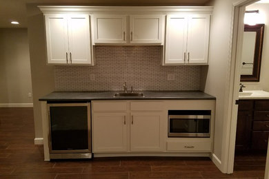 Example of a brown floor basement design in Chicago with beige walls