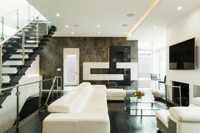Living room - large modern open concept dark wood floor and black floor living room idea in Chicago with white walls, a standard fireplace, a plaster fireplace and a wall-mounted tv