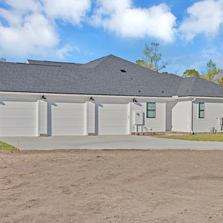 Example of a large farmhouse white one-story concrete fiberboard exterior home design in Jacksonville with a shingle roof