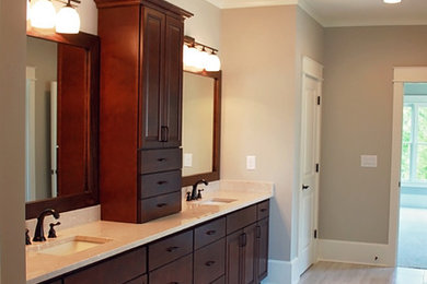Example of a mid-sized transitional master beige tile and porcelain tile porcelain tile bathroom design in Atlanta with an undermount sink, shaker cabinets, dark wood cabinets, marble countertops, a one-piece toilet and beige walls