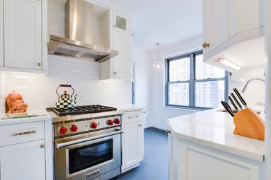 Inspiration for a mid-sized transitional u-shaped gray floor eat-in kitchen remodel in Other with an undermount sink, shaker cabinets, white cabinets, stainless steel appliances and no island