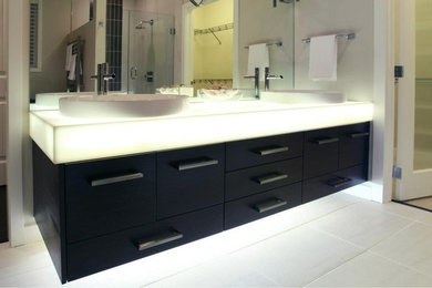 Example of a minimalist bathroom design in Calgary with solid surface countertops