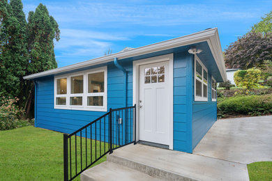 Inspiration for a small coastal blue one-story tiny house remodel in Portland with a hip roof, a shingle roof and a gray roof